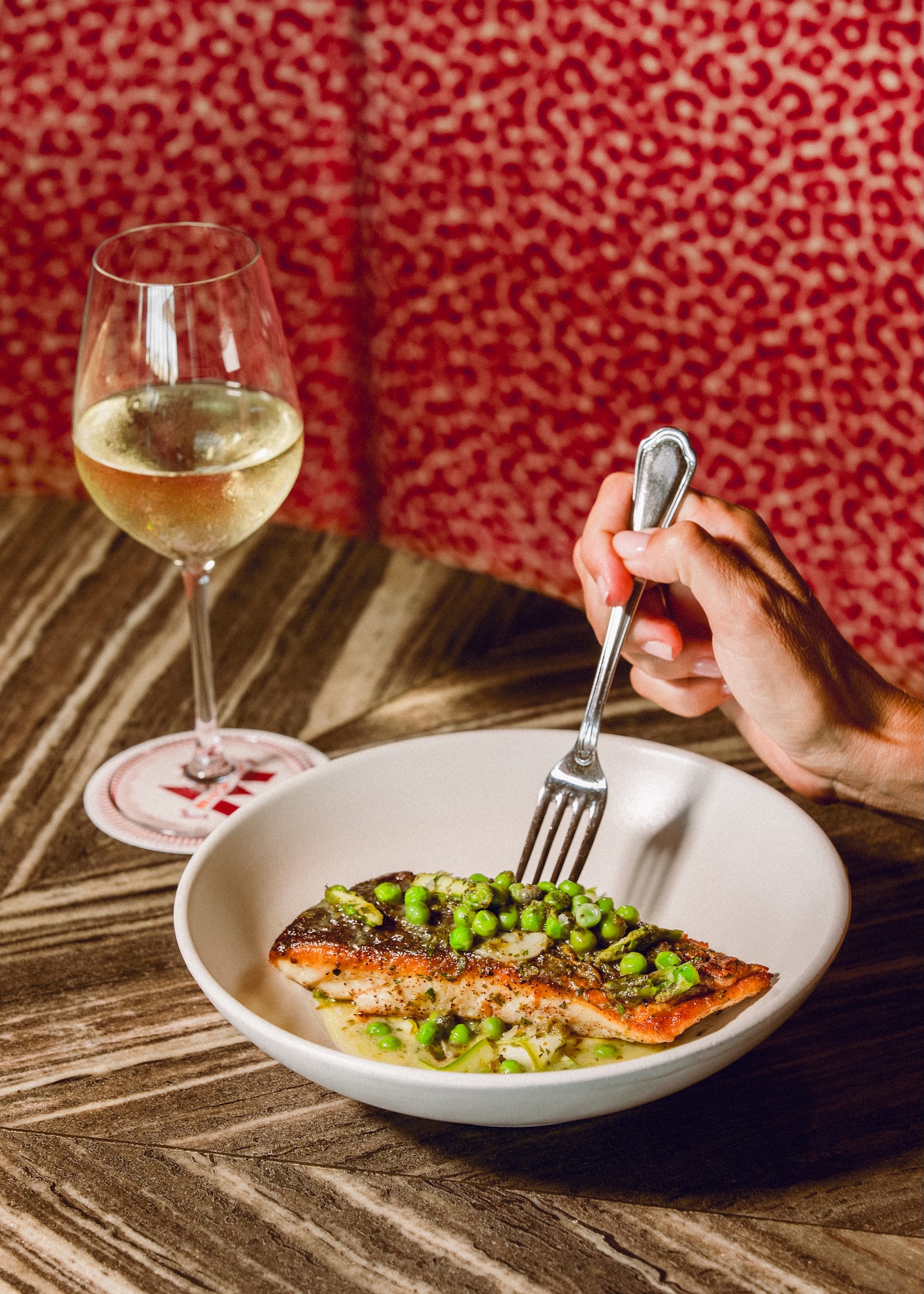 Pan-seared salmon with peas, served with white wine