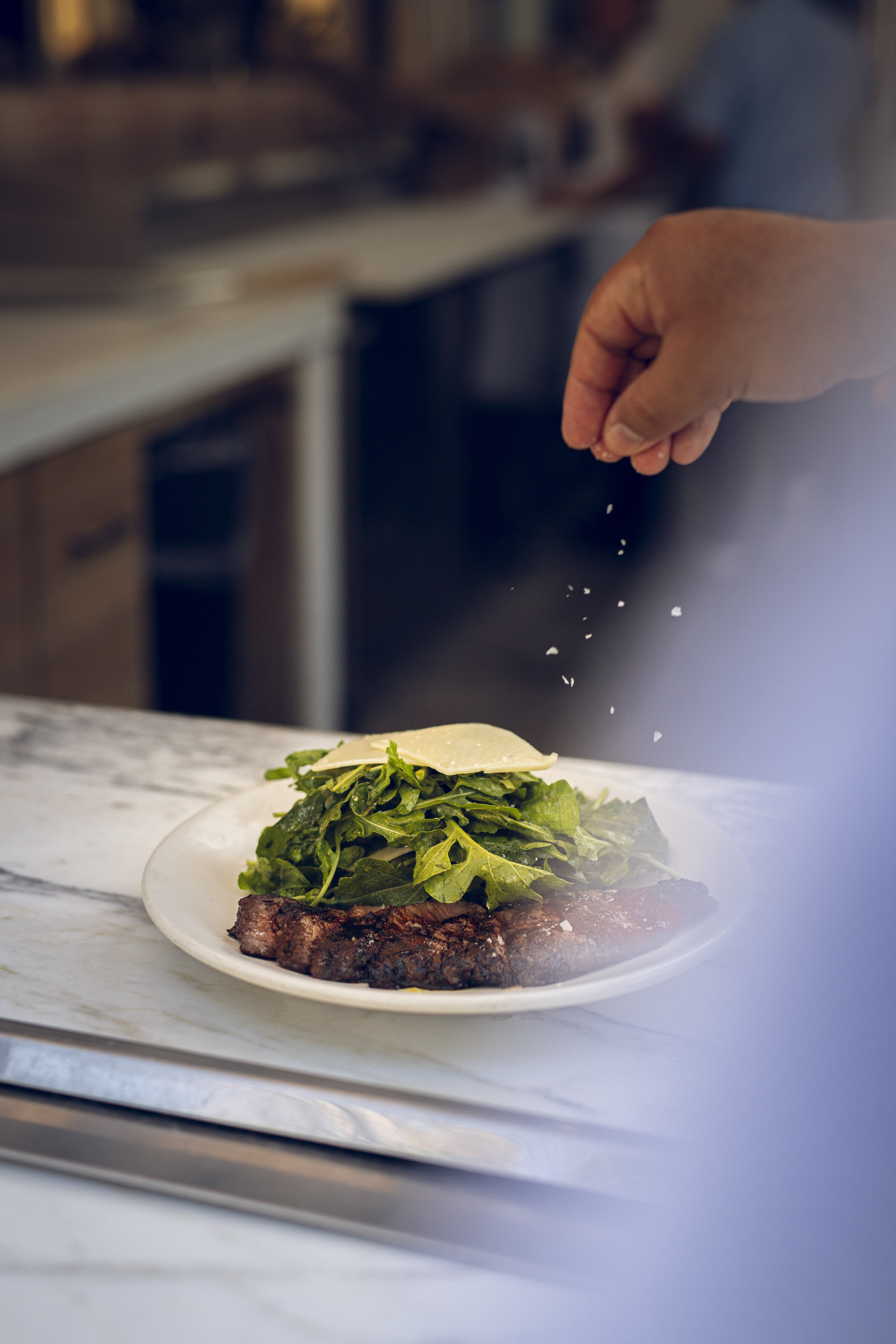 Grilled steak with arugula and shaved parmesan